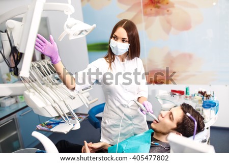 Overview of dental caries prevention.man at the dentist\'s chair during a dental procedure. Beautiful man smile close up. Healthy Smile. Beautiful male Smile