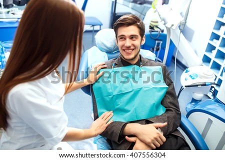 Overview of dental caries prevention. man at the dentist\'s chair during a dental procedure. Healthy Smile.