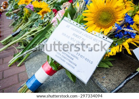 Kiev, Ukraine - 17 July 2015: People place flowers and light candles in commemoration of the victims of Malaysia Airlines MH17 plane accident in eastern Ukraine, in front of the Dutch embassy