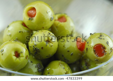 green olive oil stuffed with pimento , spiced with basil and olive oil