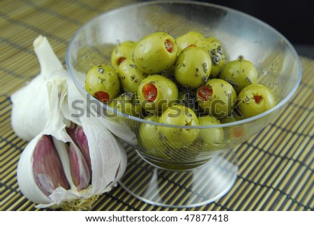 green olives stuffed with pimento ,spiced with basil and olive oil