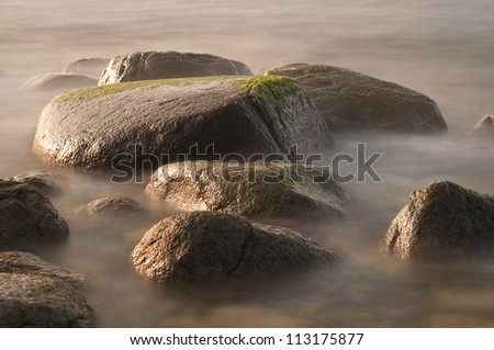 stones in the water at evening sun, long time exposure