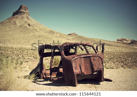 rusty car wreck in desert, vintage style, Route 66, Arizona, USA