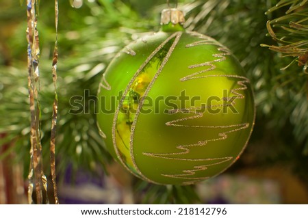 Closeup of green Christmas ball hanging on christmas tree
