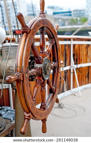 Wooden Ship wheel close up on a sailboat.