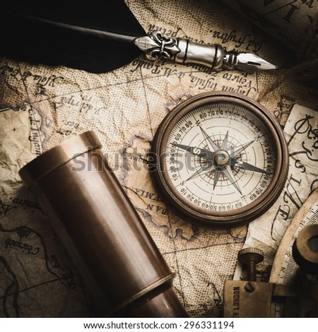 vintage still life with compass,sextant spyglass and old map