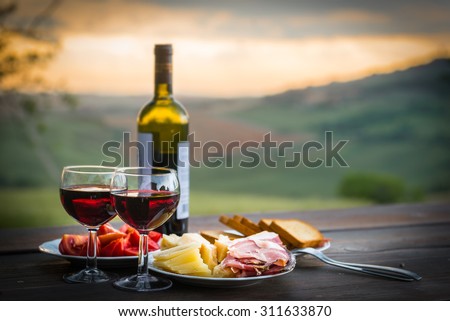 still life Red wine  ,cheese and prosciutto. Romantic dinner  outdoors