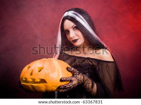 Halloween witch with a pumpkin. Smoke background