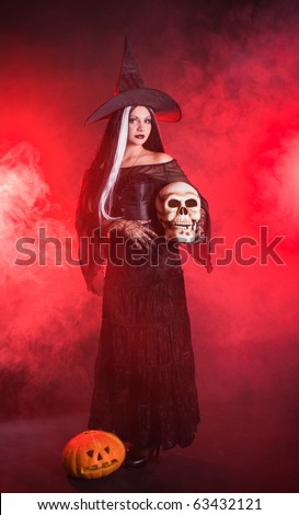 Halloween witch with a skull and pumpkin with red smoke