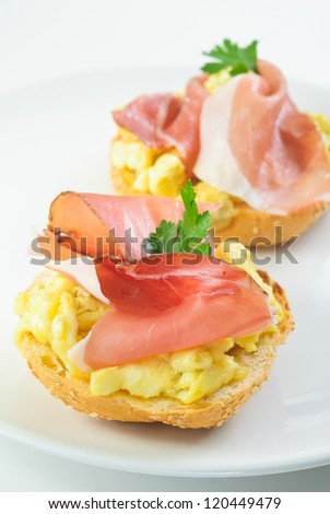Ham and scrambled eggs sandwich on a plate