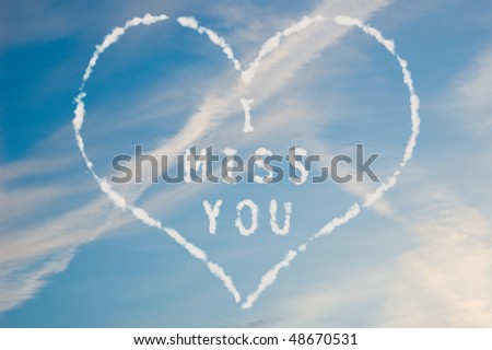 The letters I miss you written with cloud letters surrounded by a heart.