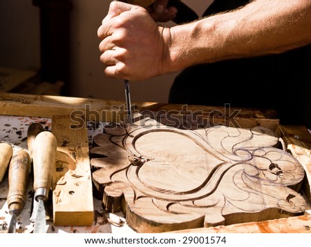 Craftsman carving a souvenir from wood