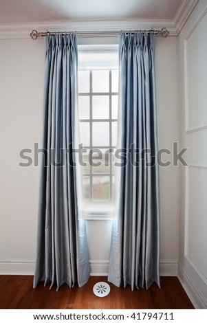 Luxury model home window coverings using wrought iron rods and side panels