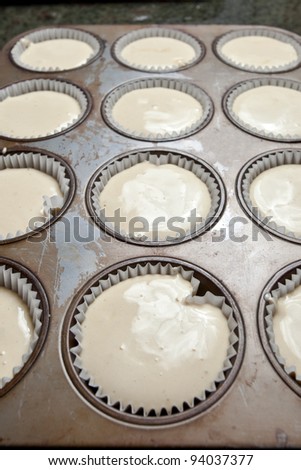 Making cupcakes, pouring into the cupcake tin