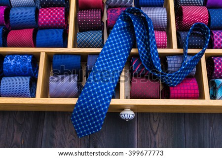 neckties showcase at store. Collection of coiled neckties in display and one flat necktie on top of others
