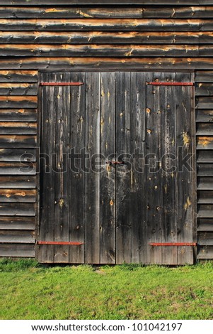 Barn Door Background - Closed barn doors on a farm building, with old weathered wooden planks.