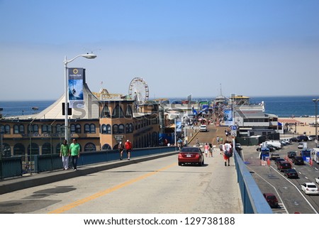 SANTA MONICA, CALIFORNIA - JULY 1: Santa Monica Pier stretches out into the Pacific Ocean on July 1, 2012 in Santa Monica, California. The pier opened in 1909 and now has an aquarium and a carousel.