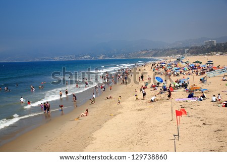 SANTA MONICA, CALIFORNIA - JULY 1: Santa Monica beachgoers on July 1, 2012 in Santa Monica, California. The city has 3.5 miles of beach locations and averages 340 days of sunshine every year.
