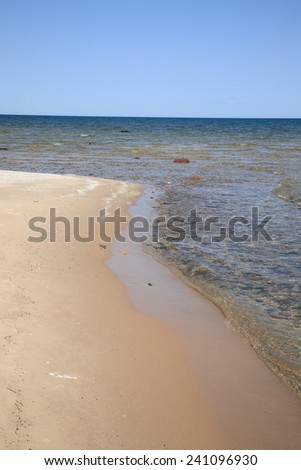 Seashore - Lake Huron. Waves reach long rocky shoreline beach of Great Lakes in Michigan