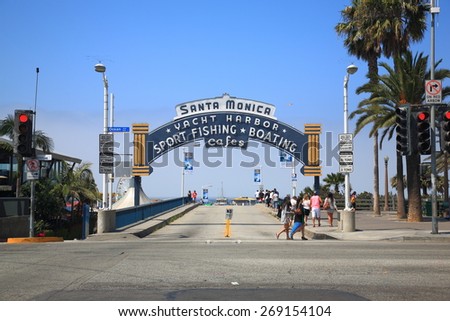 SANTA MONICA, CALIFORNIA - JULY 1: Beach goers at the Santa Monica Pier on Ocean Ave. on July 1, 2012 in Santa Monica, California. The city has 3.5 miles of beaches and 340 days of sunshine a year.