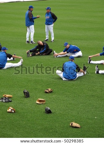 NEW YORK - MAY 26: Mets pitchers, including John Maine, stretch before a game at Citi Field with gloves scattered, on May 26, 2009 in New York.