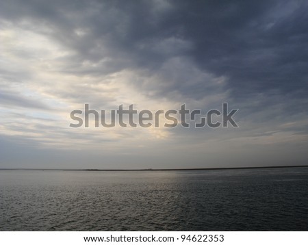 Stormy Weather Seascape - Bad weather rolls in on a lake, with waves and dark clouds.