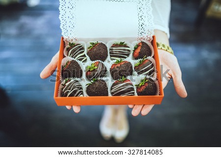 chocolate covered strawberries.  in the woman hands