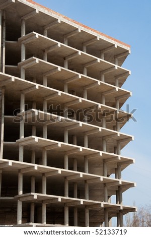 unfinished apartment building against the blue sky