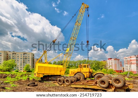 Mobile crane on a background of blue sky
