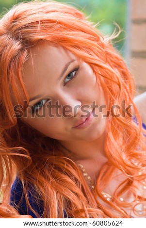 Portrait of a beautiful young ginger woman looking into camera