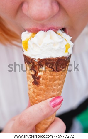 Close-up of young woman eating ice cream cone