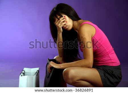 Woman looking at bag and very tired after shopping