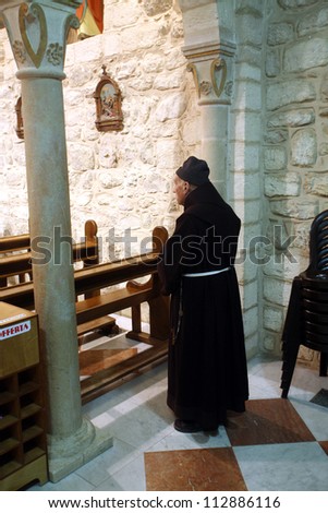 CANA , ISRAEL - DECEMBER 30: Franciscan monk in the Church of Jesus\' first miracle. Franciscans in the Holy Land take care about most of the churches and shrines., Cana, Israel on December 30, 2007.