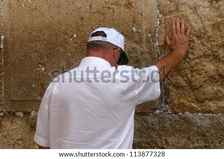 JERUSALEM - OCTOBER 03: Unidentified Jewish man prays at the western wall October 03, 2006 in Jerusalem, Israel. The wall is one of the holiest sites in Judaism attracting thousands of worshipers daily.