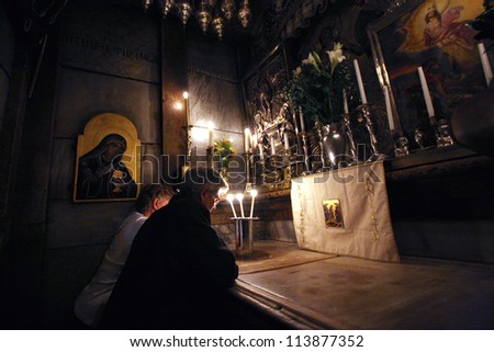 JERUSALEM - OCTOBER 01: Pilgrims pray at the tomb of Jesus in the Church of the Holy Sepulchre, in Jerusalem, Israel on Oct. 1, 2006. It is the traditional site of the crucifixion, burial, and resurrection of Jesus.