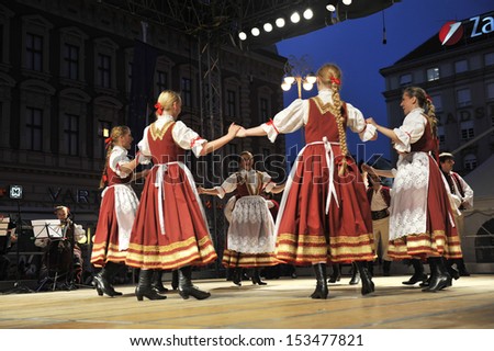 ZAGREB,CROATIA - JULY 18: Members of the ensemble song and dance Warsaw School of Economics in Polish folk costume during the 47th International Folklore Festival in Zagreb,Croatia on July 18,2013