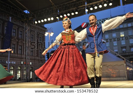 ZAGREB,CROATIA - JULY 18: Members of the ensemble song and dance Warsaw School of Economics in Polish national costume during the 47th International Folklore Festival in Zagreb,Croatia on July 18,2013