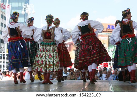 ZAGREB,CROATIA - JULY 18: Members of the ensemble song and dance Warsaw School of Economics in Polish folk costume during the 47th International Folklore Festival in Zagreb,Croatia on July 18,2013