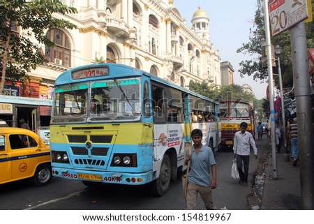 KOLKATA, INDIA - NOVEMBER 24:People on the move come in the colorful bus on November 24, 2012 in Kolkata, India. Kolkata and its suburbs, is home to approximately 14.1 million people.
