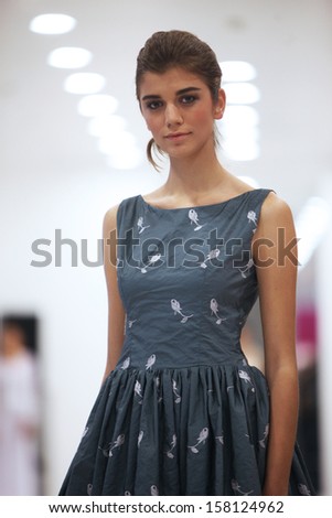 ZAGREB, CROATIA - OCTOBER 12: Fashion model in cocktail dress made by Lorien on \'Wedding Expo\' show in the Westgate Shopping City in Zagreb, Croatia on October 12, 2013