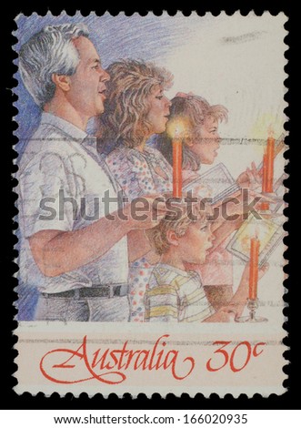 AUSTRALIA - CIRCA 1988: A Christmas stamp printed in Australia shows family singing with candles, circa 1988