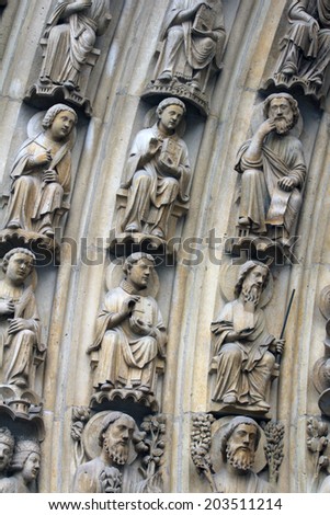 PARIS,FRANCE - NOV 05, 2012:archivolt are populated by the Heavenly Court (patriarchs, kings, and prophets), Notre Dame cathedral.The Portal of the Virgin, dedicated to the patroness of the cathedral.