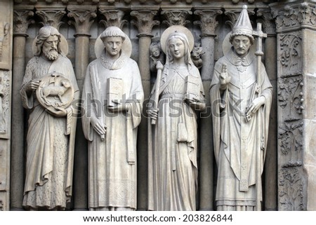 PARIS,FRANCE - NOV 05, 2012: St John the Baptist, St Stephen, St Genevieve and Pope St Sylvester, detail of Notre Dame cathedral. The Portal of the Virgin, dedicated to the patroness of the cathedral.