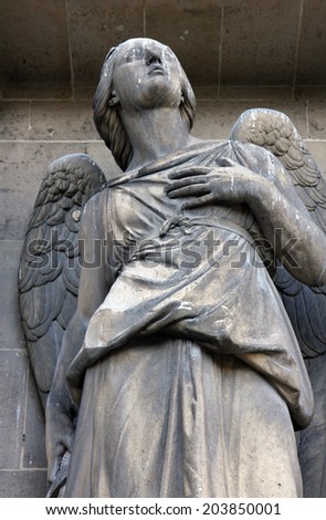 PARIS, FRANCE - NOV 09, 2012: Archangel Michael, architectural details of Eglise de la Madeleine. Madeleine Church was designed in its present form as a temple to the glory of Napoleon\'s army.