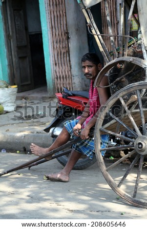 KOLKATA - FEB 12: rickshaw driver working on February 12, 2014 in Kolkata, India. Rickshaws have been around for more than a century, but they could soon be a thing of the past.