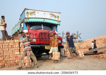 SARBERIA,INDIA, JANUARY 16: Brick field workers carrying complete finish brick from the kiln, and loaded it onto a truck on January 16, 2009 in Sarberia, West Bengal, India.