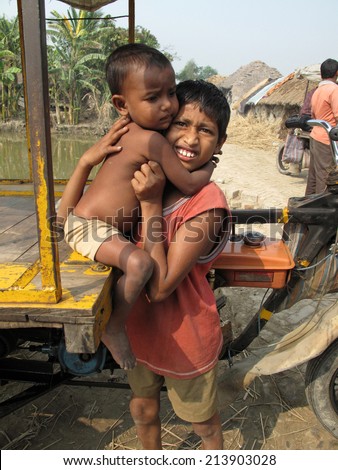 SUNDARBANS, WEST BENGAL, INDIA - JANUARY 18: Sayan Payne, 12, holding his little brother Rajneesh, 3, at remote village in Sundarbans, West Bengal, India on January 18, 2009.