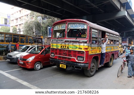 KOLKATA, INDIA - FEBRUARY 10:People on the move come in the colorful bus on February 10, 2013 in Kolkata, India. Kolkata and its suburbs, is home to approximately 14.1 million people.