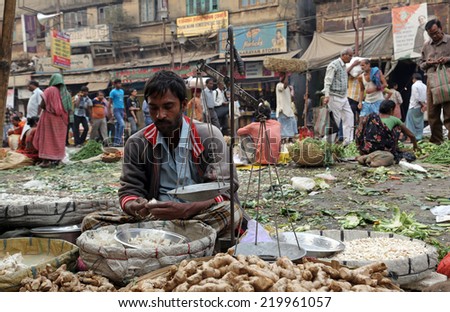 KOLKATA, INDIA - FEBRUARY 11: Street trader sell vegetables outdoor on February 11, 2014 in Kolkata India. Only 0.81% of the Kolkata\'s workforce employed in the primary sector (agriculture)