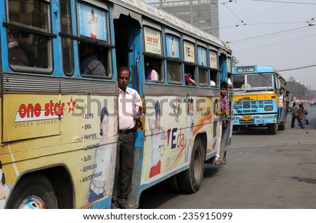 KOLKATA, INDIA - FEBRUARY 08: People on the move come in the colorful bus on February 08, 2013 in Kolkata, India. Kolkata and its suburbs, is home to approximately 14.1 million people.